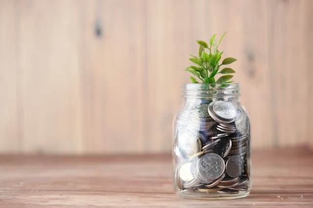 A glass jar of saved coins