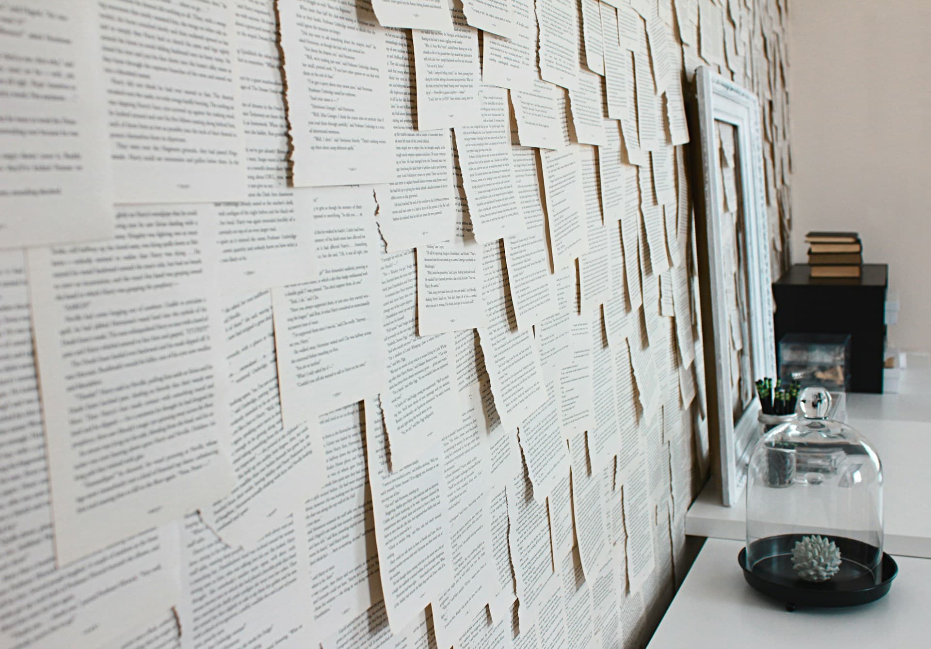 Loose paperwork stacked and scattered across a desk